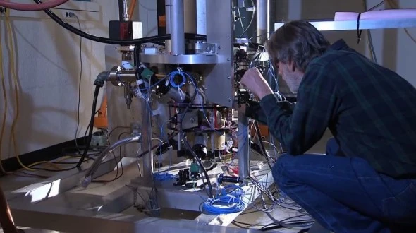 Tom Heavner with the NIST-F2 cesium fountain atomic clock