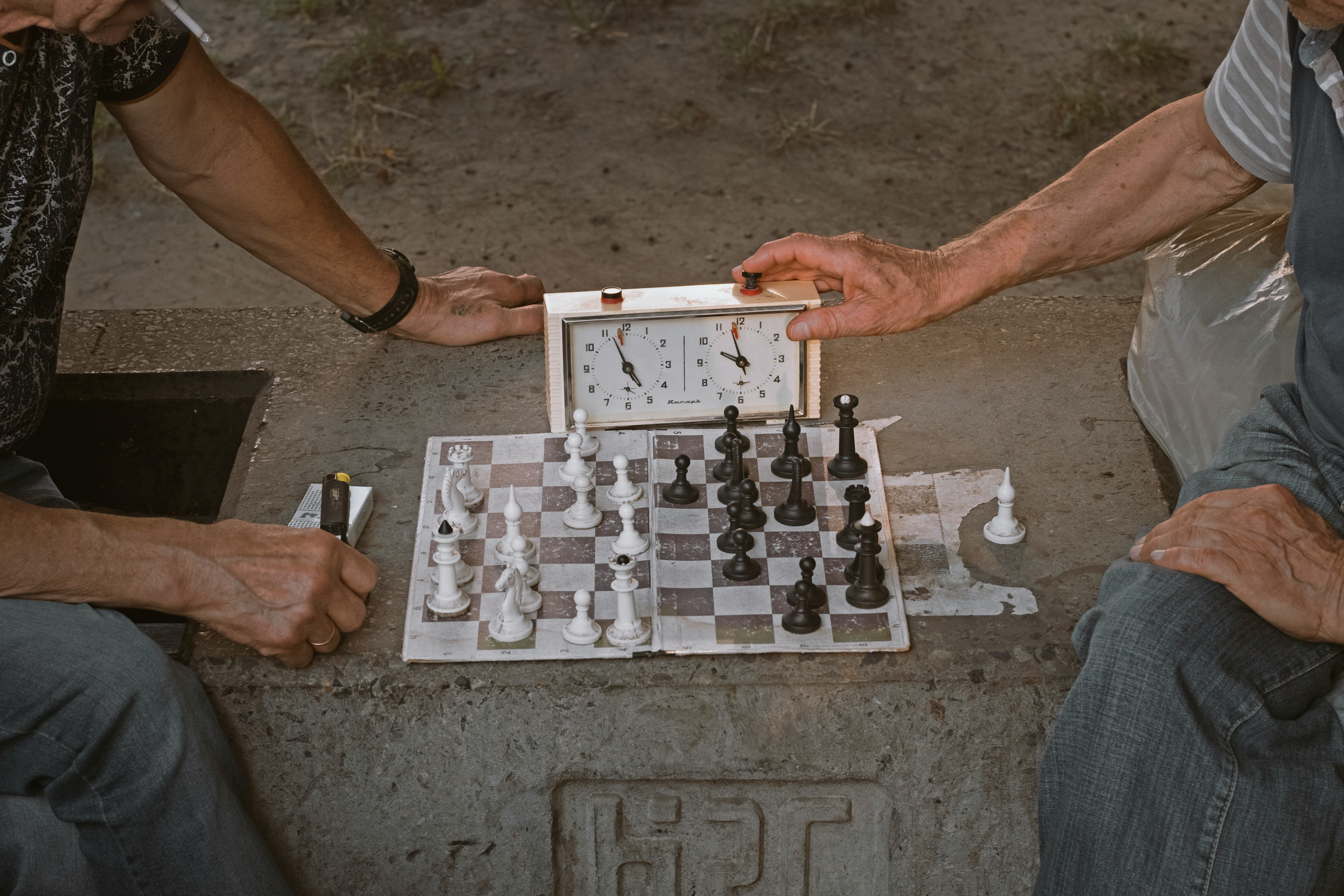 Two man playing chess with a timer